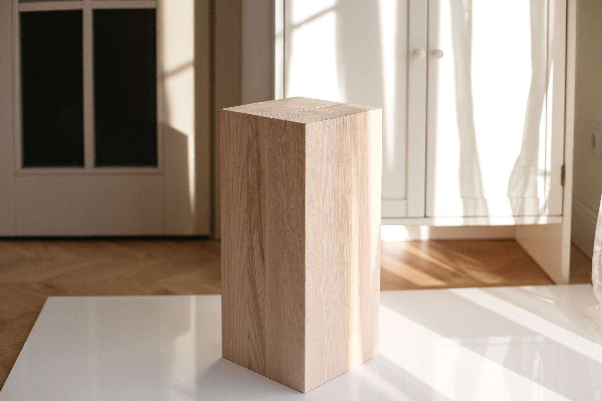 A handmade solid ash wood coffee table with a smooth, polished finish, displayed in a room with natural lighting.