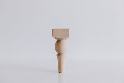 A single wooden furniture leg with a ball design at the top, displayed against a white background.