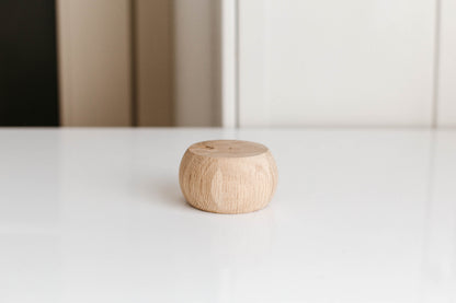 Wooden diffuser on a white surface with a neutral background