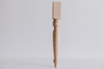 Wooden leg on a light gray background