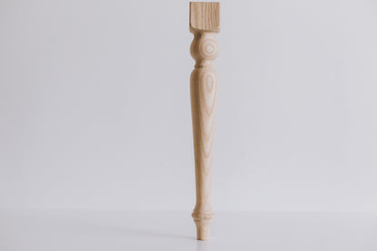 Wooden table leg on a light gray background