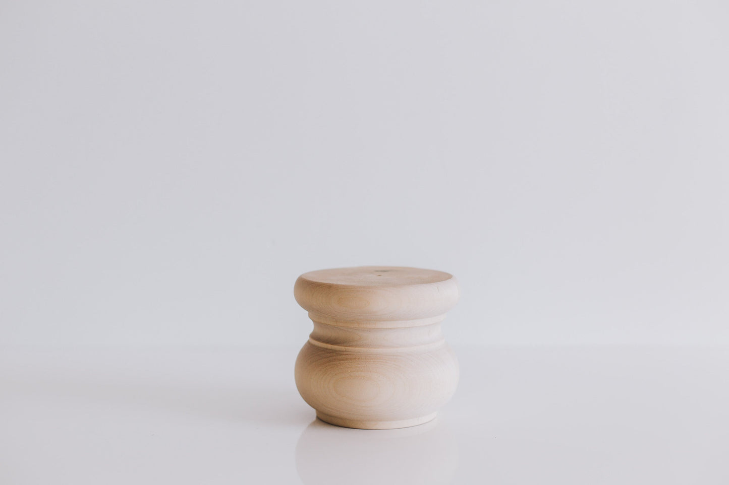 A single wooden furniture leg with a smooth finish, displayed against a white background.
