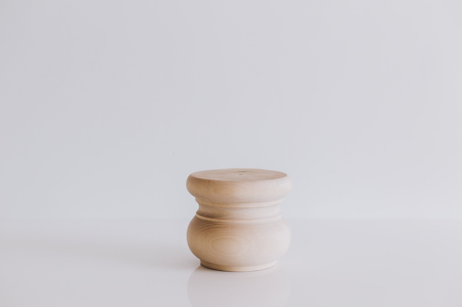A single wooden furniture leg with a smooth finish, displayed against a white background.